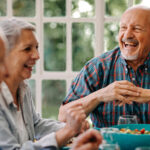 A group of seniors gather together during a meal
