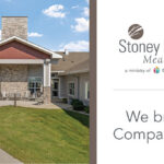 Exterior view of Stoney Point Meadows senior living community in Cedar Rapids, featuring landscaped grounds, walking path, and main entrance with seating area.