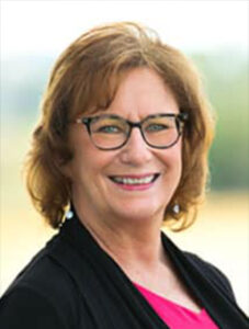 Employee portrait outdoors with a soft natural background at Stoney Point Meadows