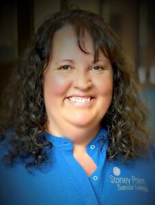 Employee portrait indoors with a neutral background at Stoney Point Meadows